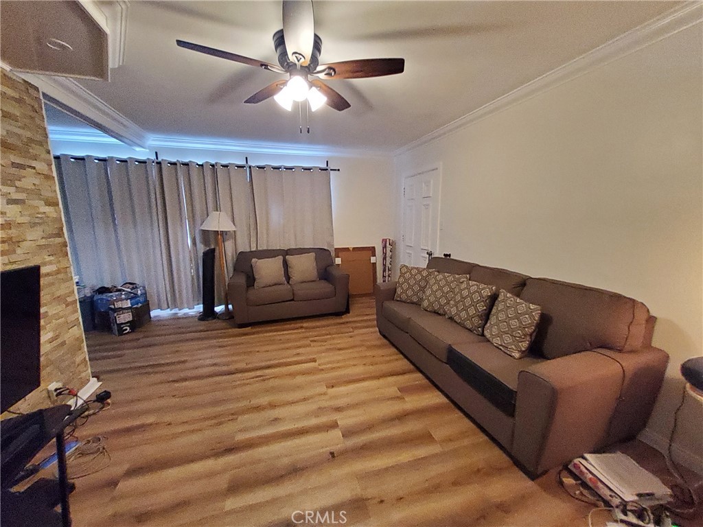 728 Cedar Avenue, Unit 29 Long Beach, CA 90813 - Photo 2 of 14 a living room with furniture and a flat screen tv