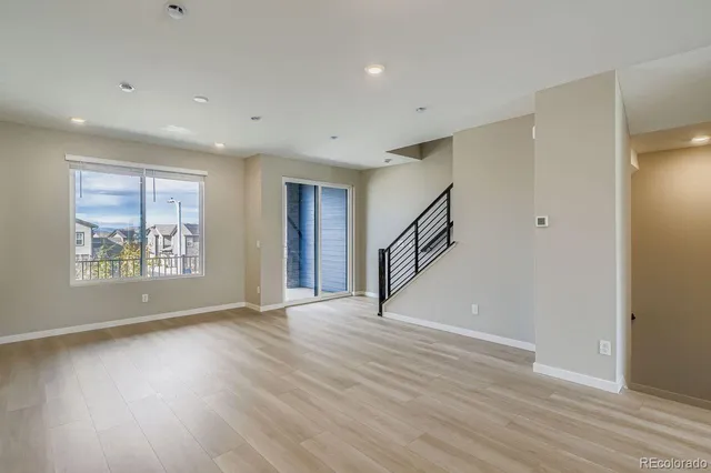 a view of a balcony with wooden floor & fence
