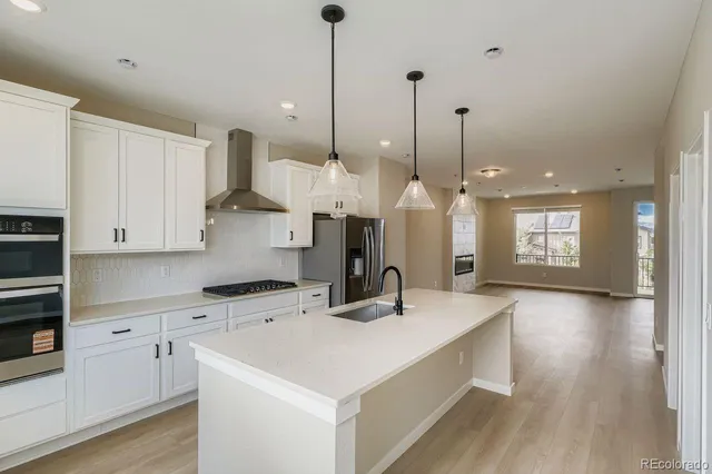 a kitchen with refrigerator a sink and cabinets