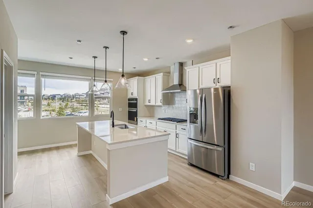 a very nice looking room with a large window and wooden floor