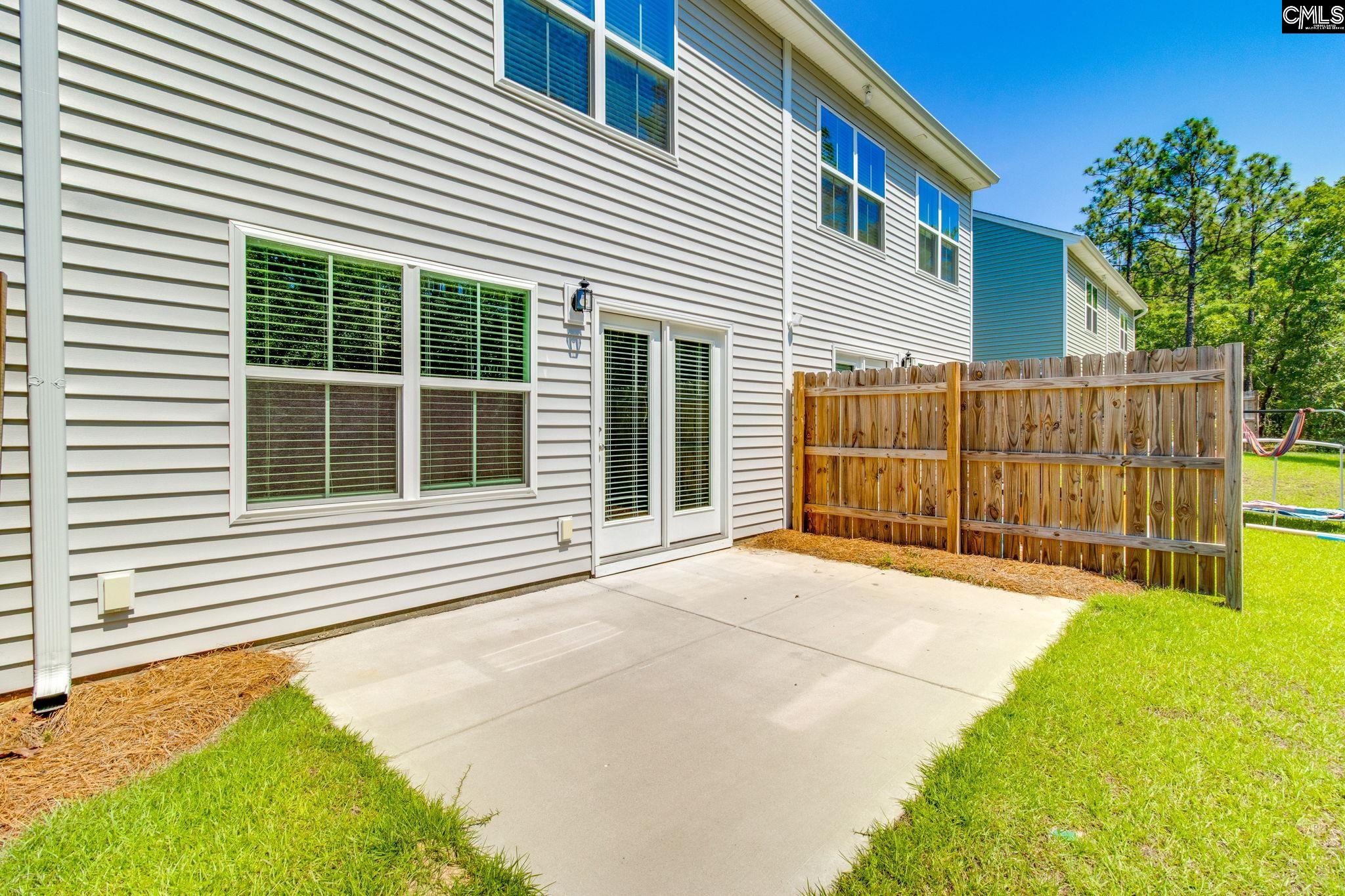 312 Reedmace Court Lexington, SC 29072 - Photo 26 of 29 a view of backyard with a small cabin and wooden fence