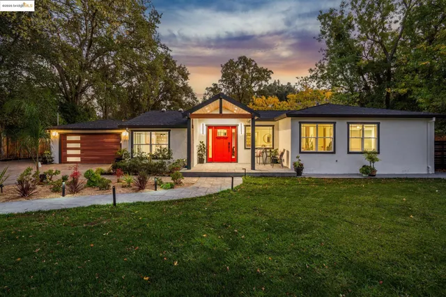 a view of a house with a backyard and porch