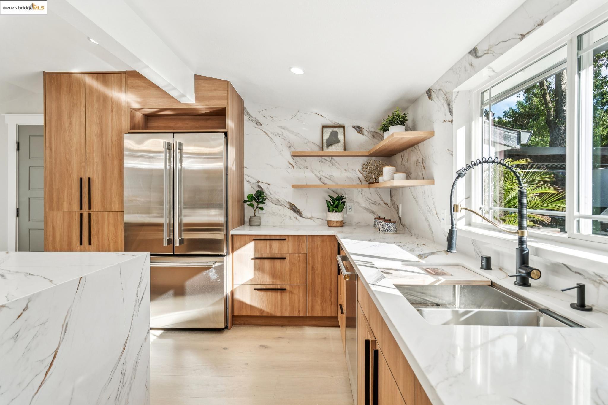 1333 Milton Avenue Walnut Creek, CA 94596 - Photo 12 of 59 a large kitchen with kitchen island a large window a sink and stainless steel appliances