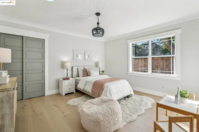 a bedroom with a bed and a chandelier