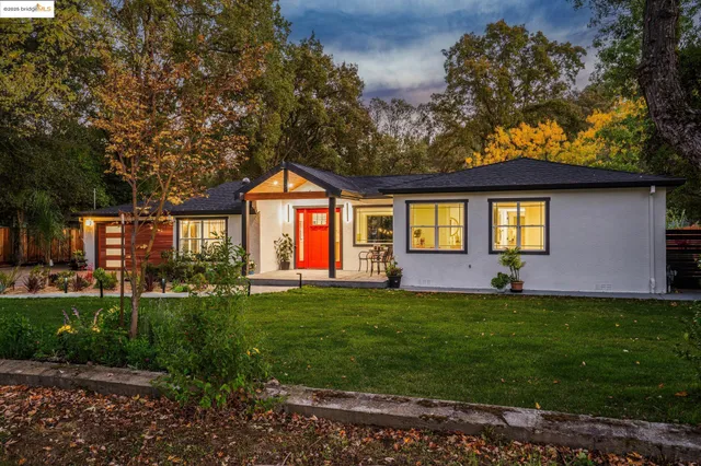 a front view of a house with a garden