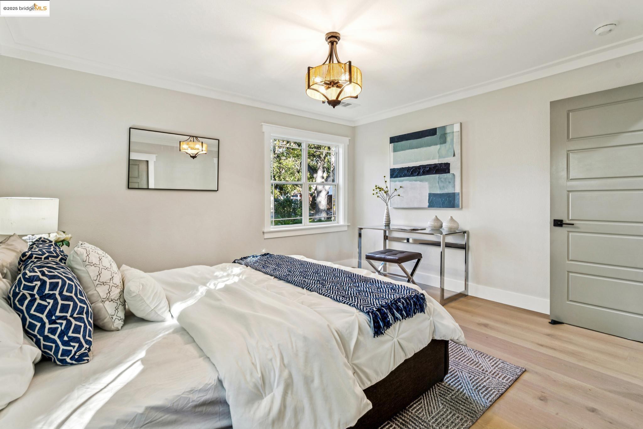 1333 Milton Avenue Walnut Creek, CA 94596 - Photo 31 of 59 a bedroom with a bed a chandelier and a window