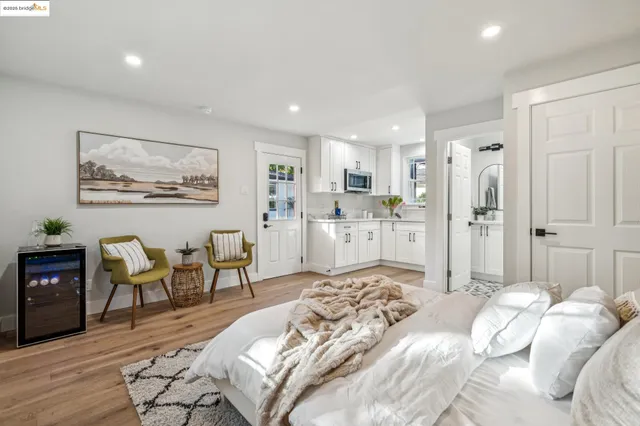 a living room with patio furniture and a wooden floor