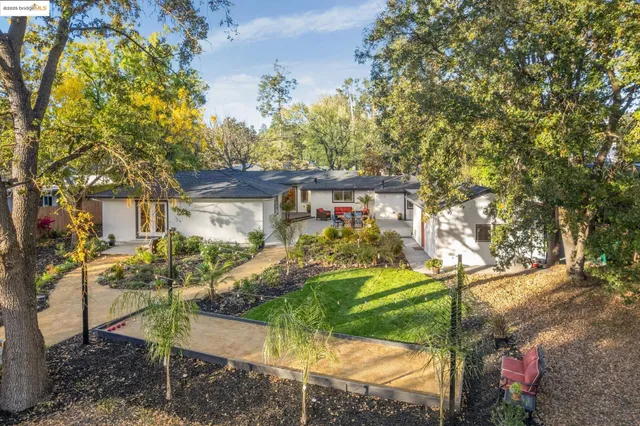 a front view of house with yard and outdoor seating