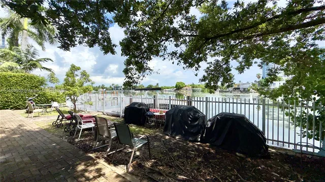 a view of a roof deck with table and chairs and wooden fence