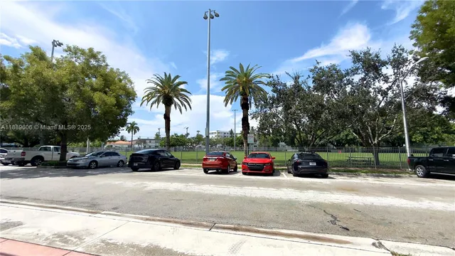 a view of car parked on the side of a street