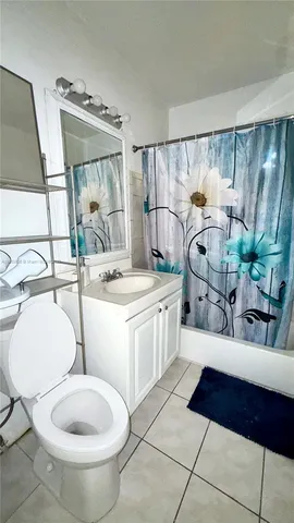 a bathroom with a sink mirror vanity and toilet