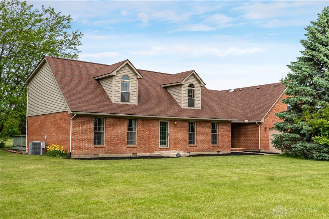9981 Ridge Acres Lane Englewood, OH 45322 - Photo 5 of 73 This classic brick residence features a spacious yard and inviting dormer windows.