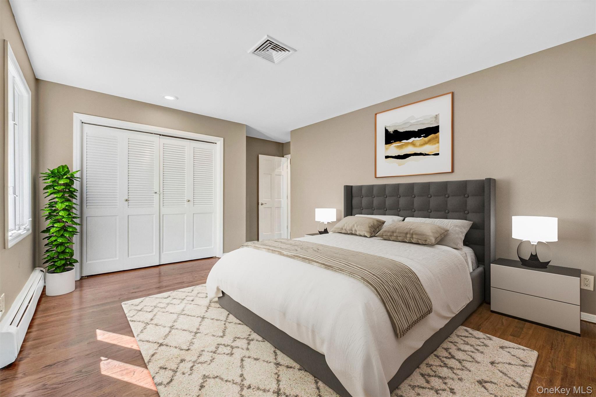 18 Millbank Road Poughkeepsie, NY 12603 - Photo 26 of 50 a spacious bedroom with a bed and a painting on the wall