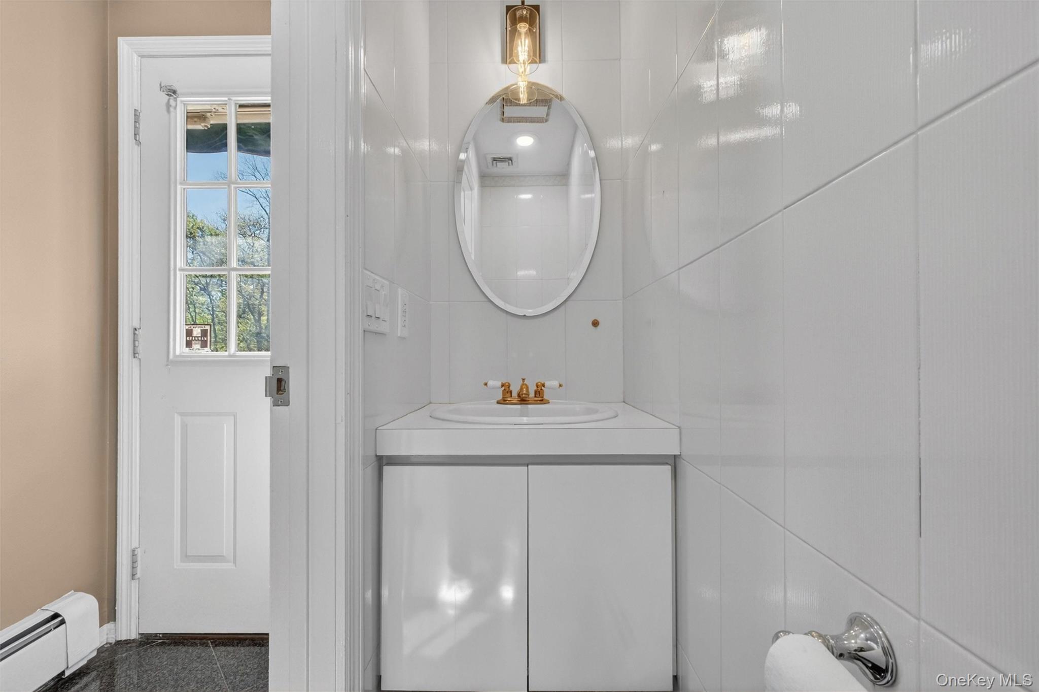 18 Millbank Road Poughkeepsie, NY 12603 - Photo 31 of 50 a bathroom with a sink and a mirror