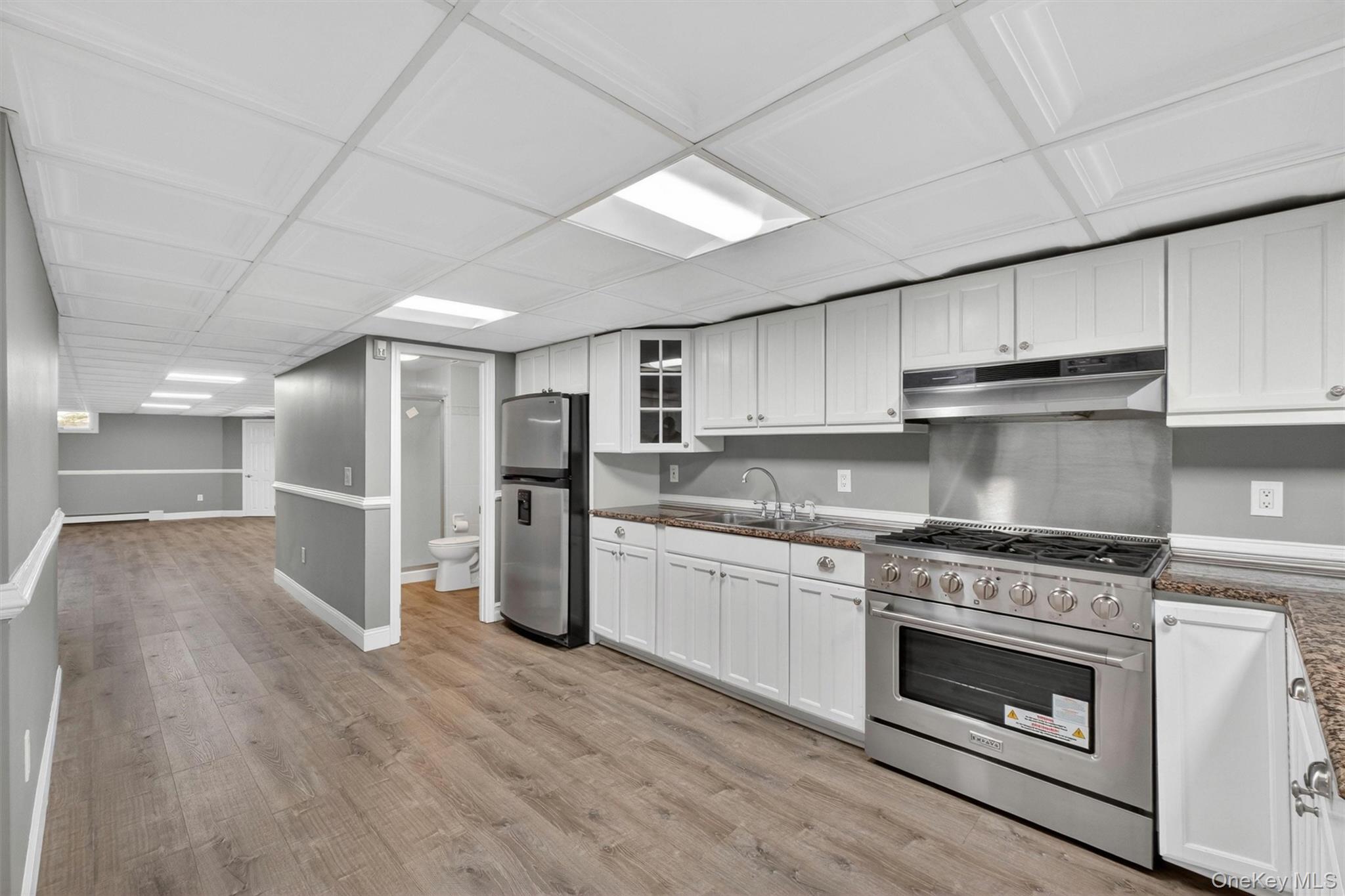 18 Millbank Road Poughkeepsie, NY 12603 - Photo 34 of 50 a kitchen with granite countertop a stove top oven and cabinets
