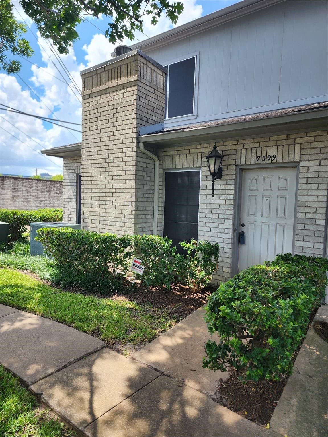 7399 Regency Square Court, Unit 7399 Houston, TX 77036 - Photo 1 of 27 a front view of a house with garden