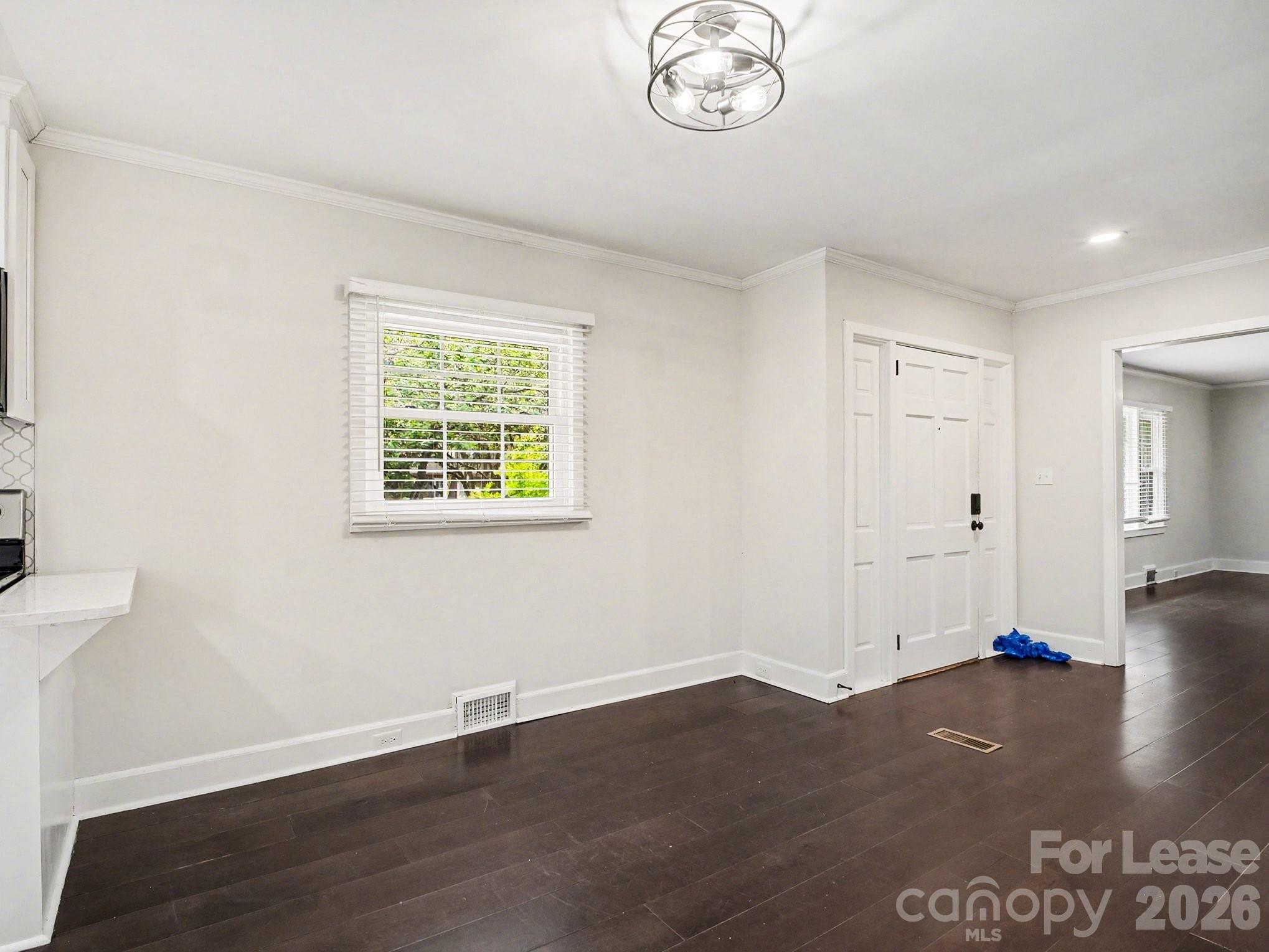 782 Union Street South Concord, NC 28025 - Photo 14 of 28 an empty room with wooden floor and windows