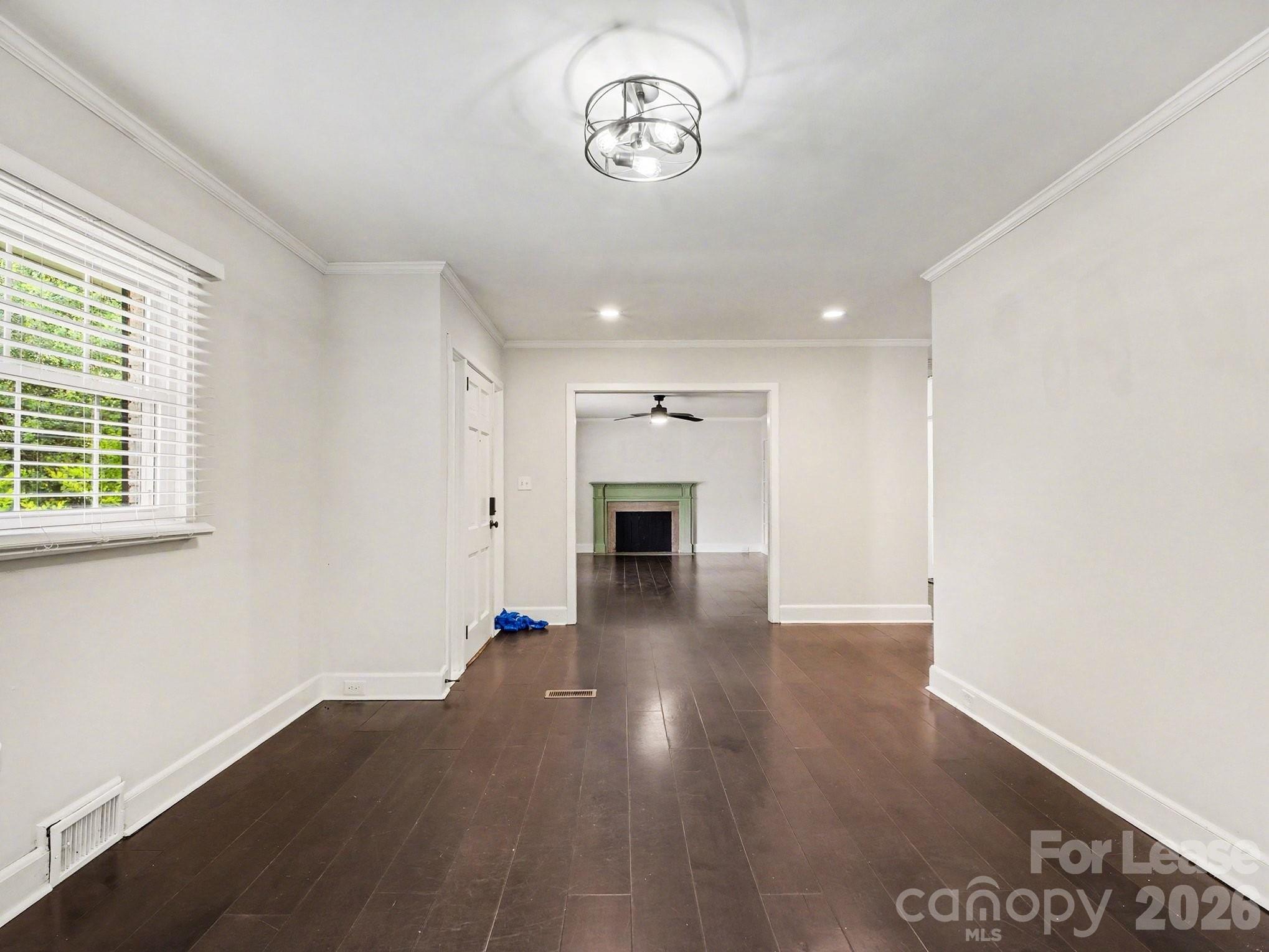 782 Union Street South Concord, NC 28025 - Photo 15 of 28 an empty room with wooden floor fireplace and windows
