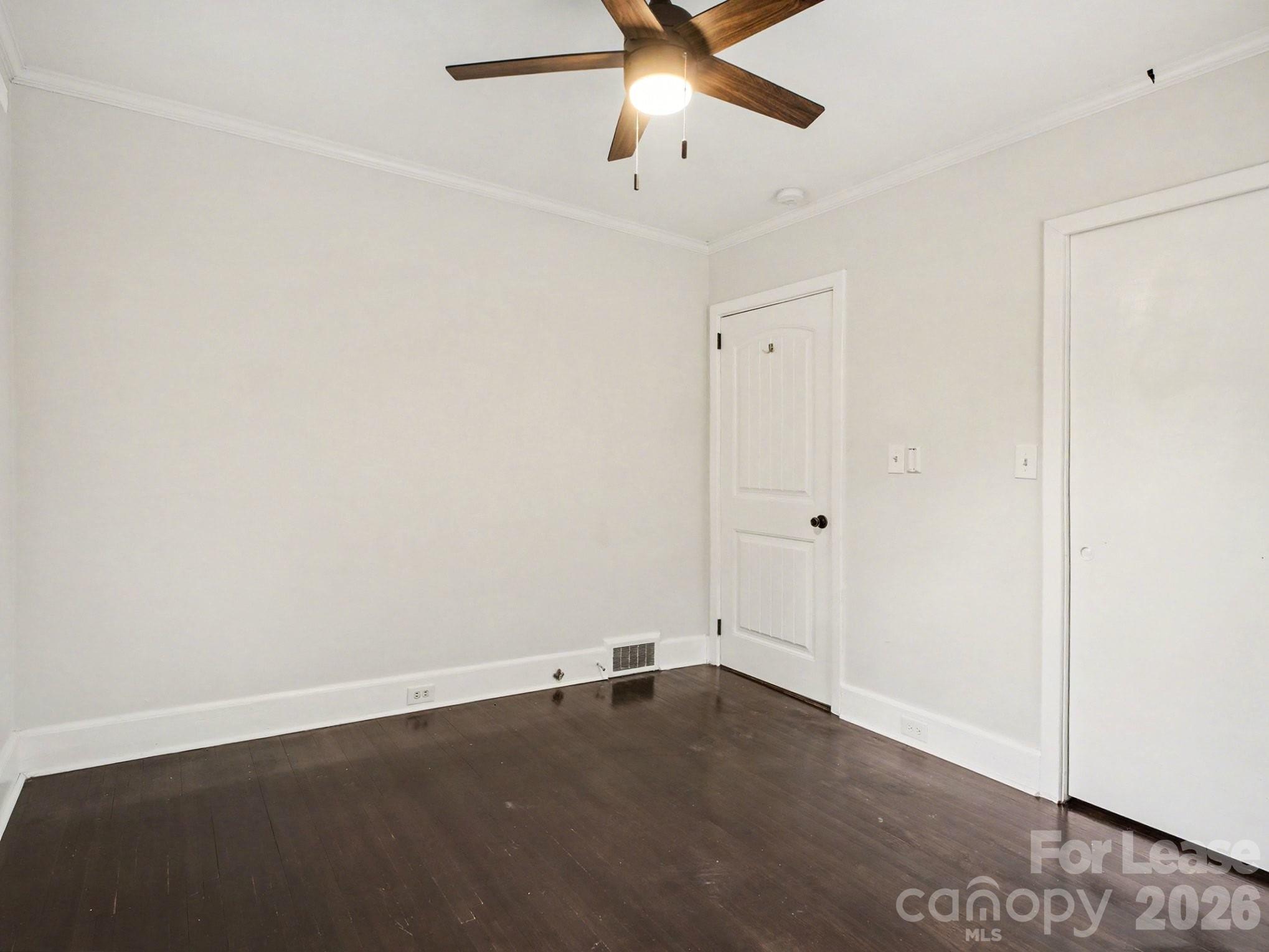 782 Union Street South Concord, NC 28025 - Photo 25 of 28 an empty room with a ceiling fan and wooden floor