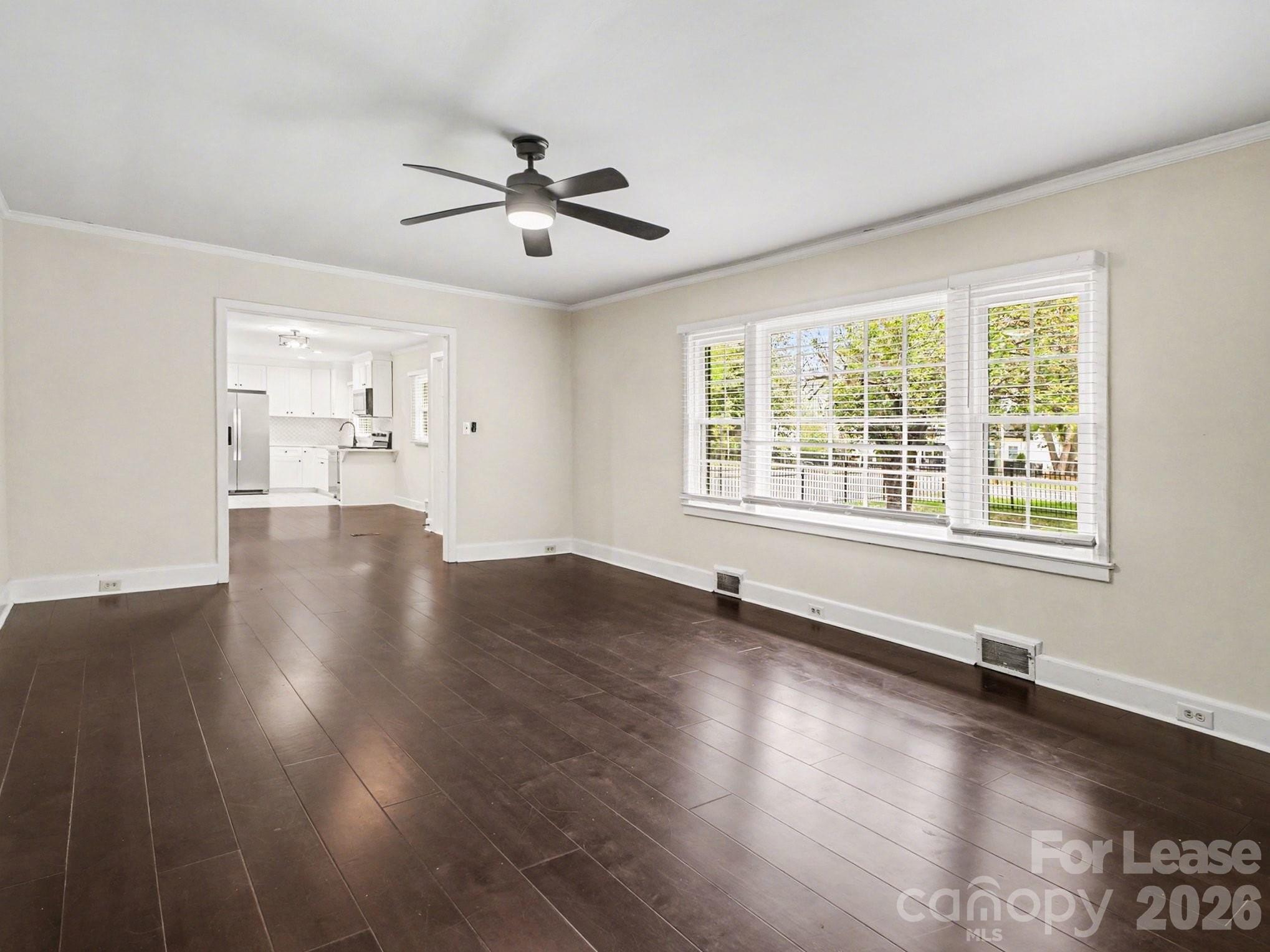 782 Union Street South Concord, NC 28025 - Photo 8 of 28 a view of an empty room with wooden floor and a window