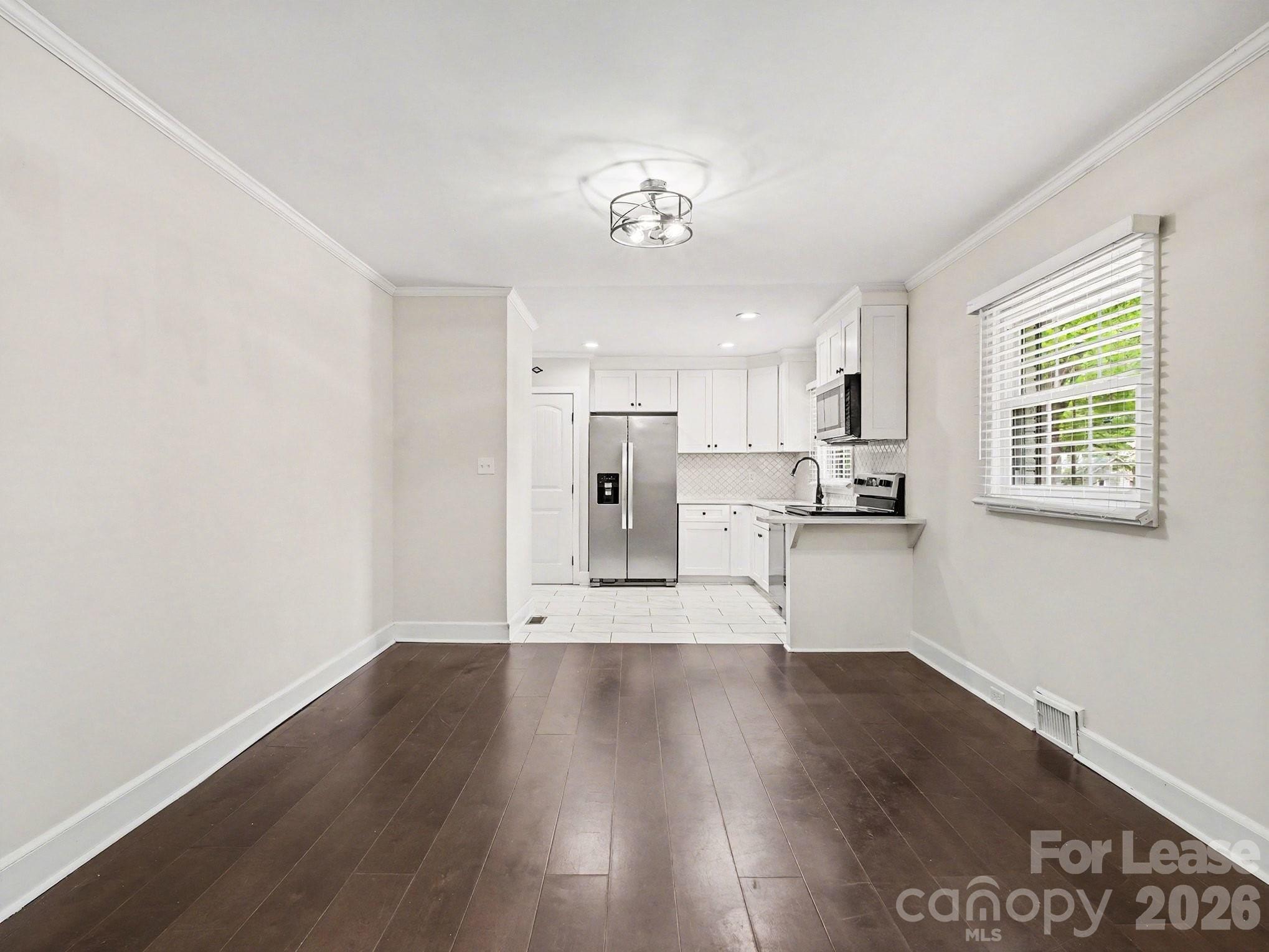 782 Union Street South Concord, NC 28025 - Photo 10 of 28 a view of a kitchen with wooden floor