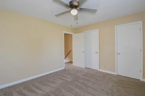 a view of an empty room with a ceiling fan