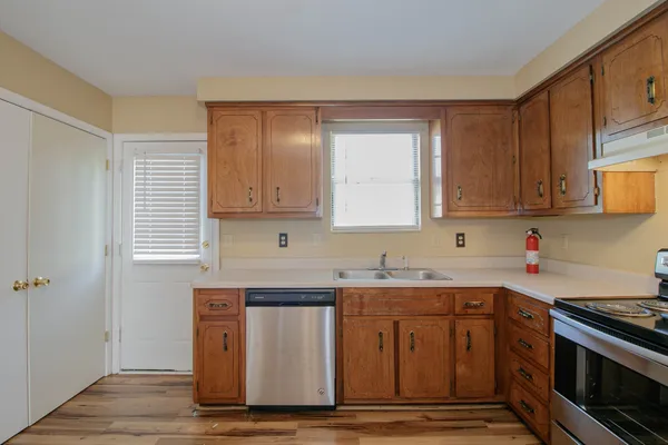 a kitchen with stainless steel appliances granite countertop a stove a sink and a microwave