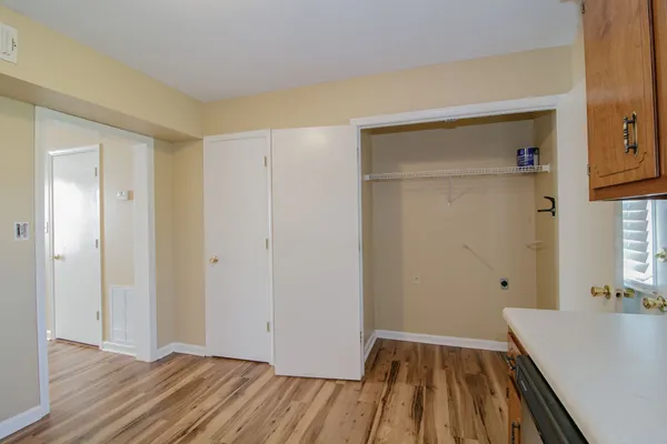a view of a room with wooden floor and a sink