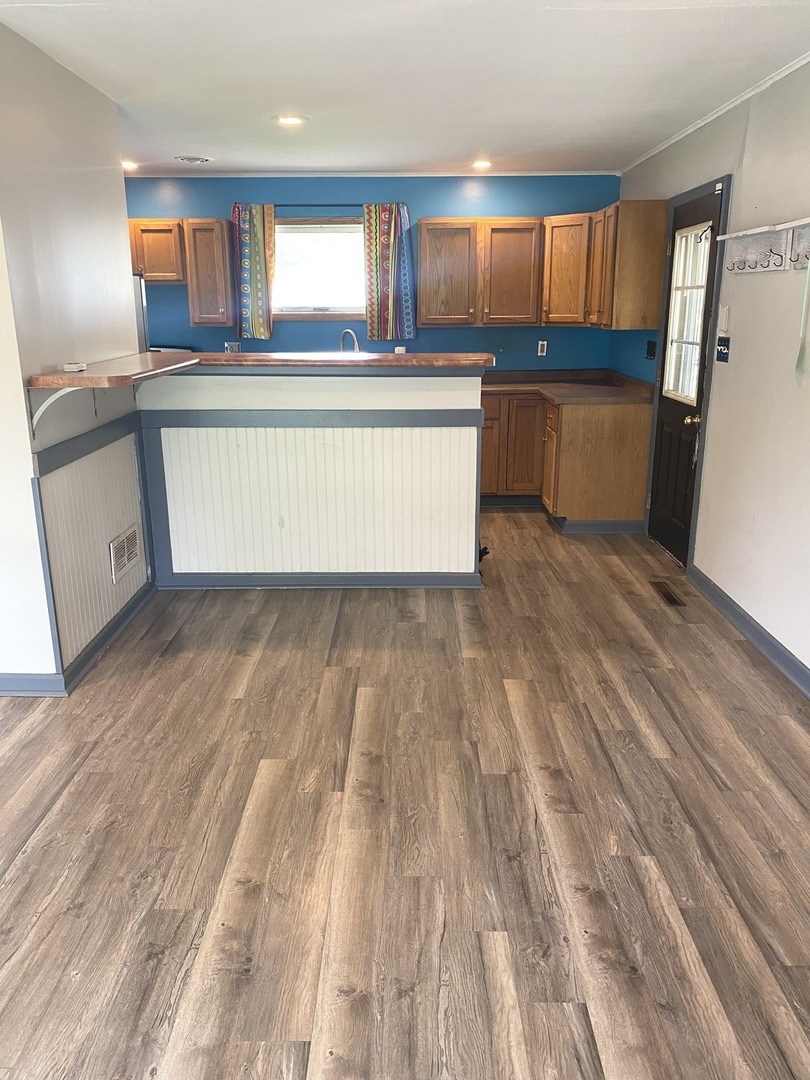 614 North Reed Street Joliet, IL 60435 - Photo 15 of 16 a kitchen with wooden floors and refrigerator