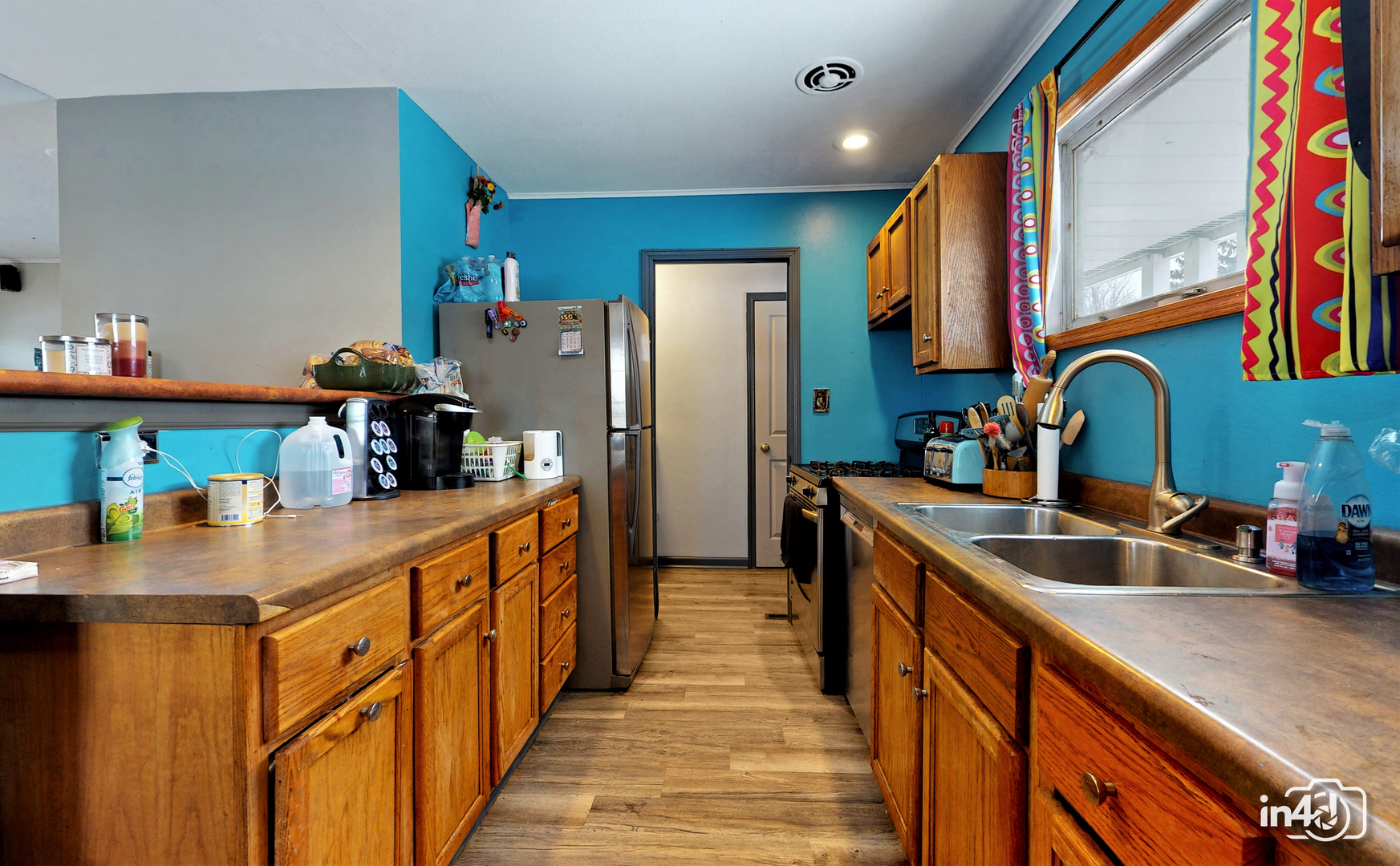 614 North Reed Street Joliet, IL 60435 - Photo 6 of 16 a kitchen with stainless steel appliances granite countertop a sink and a refrigerator