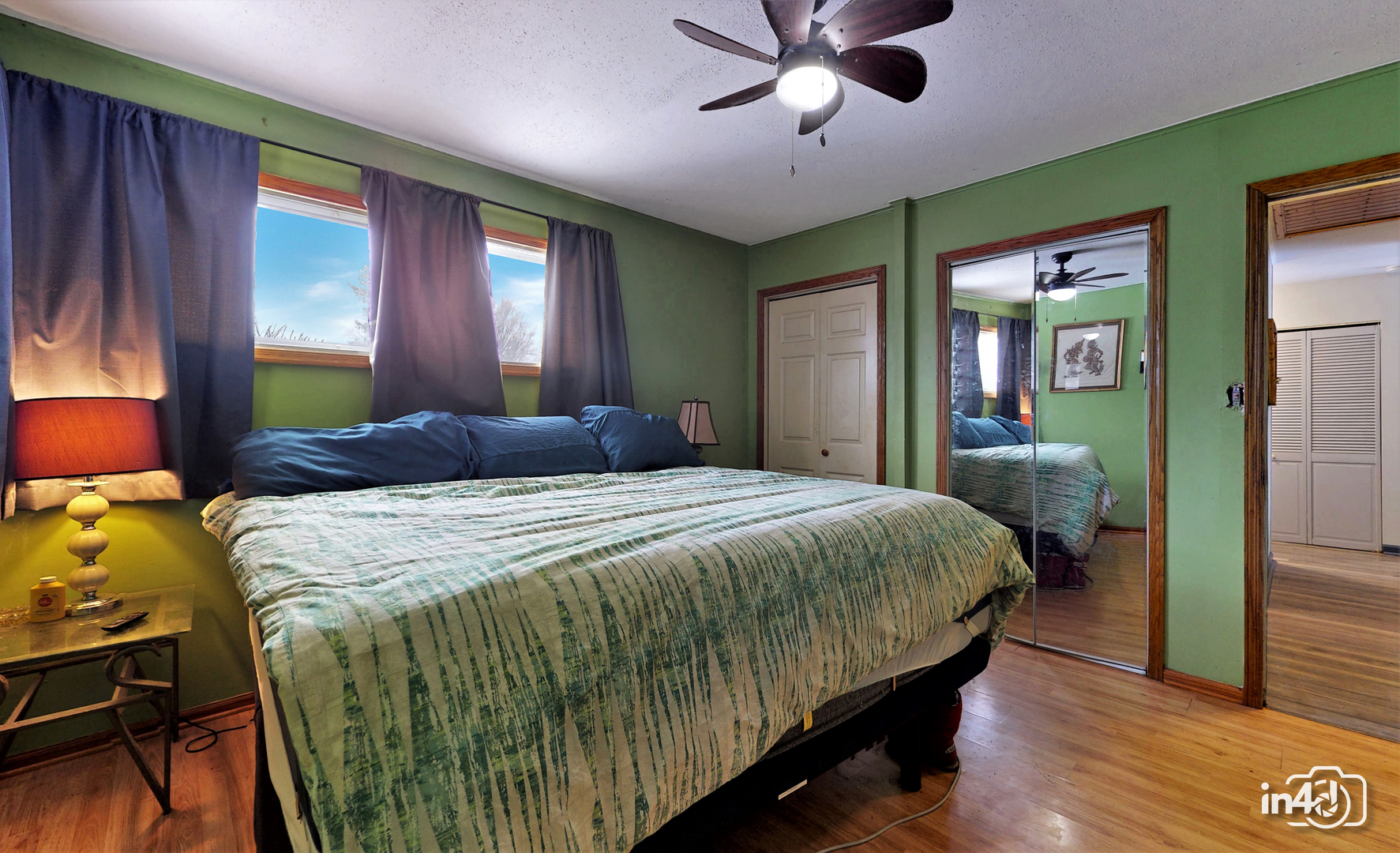 614 North Reed Street Joliet, IL 60435 - Photo 10 of 16 a bedroom with a bed and a chandelier