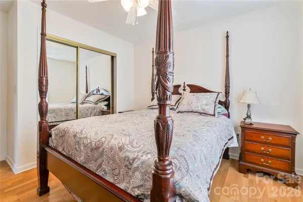 a bed sitting in a bedroom next to a window