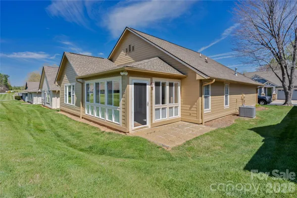 a view of a house with a yard and deck