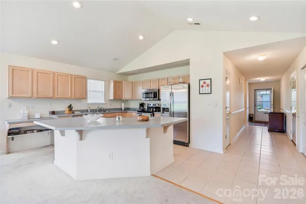 a kitchen with stainless steel appliances granite countertop a refrigerator and a sink