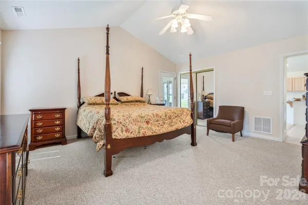 a bedroom with furniture and a chandelier