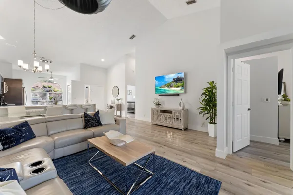 a living room with furniture and a chandelier