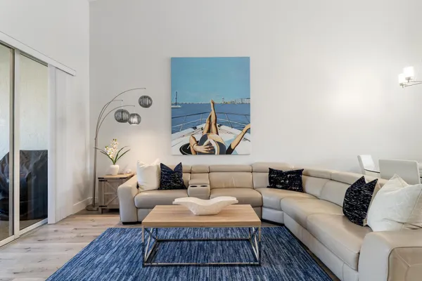 a living room with furniture and a wooden floor