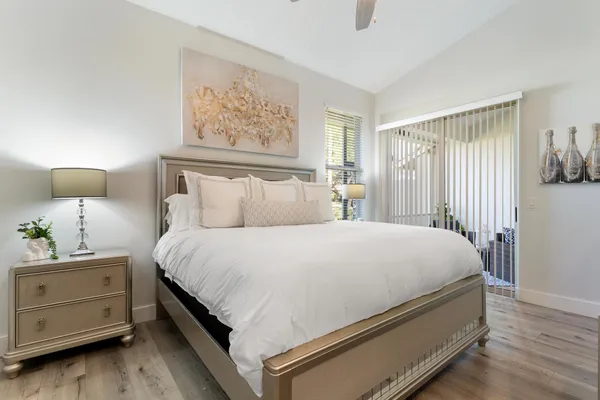 a bed sitting in a bedroom next to a lamp