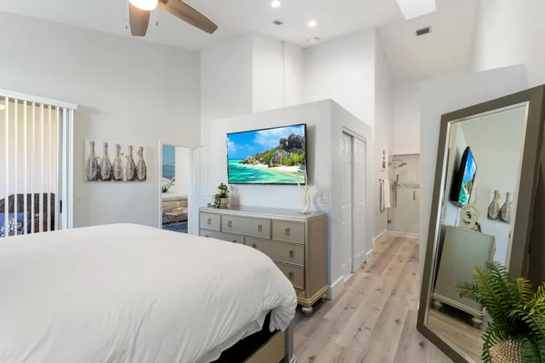 a bedroom with a bed and a flat screen tv