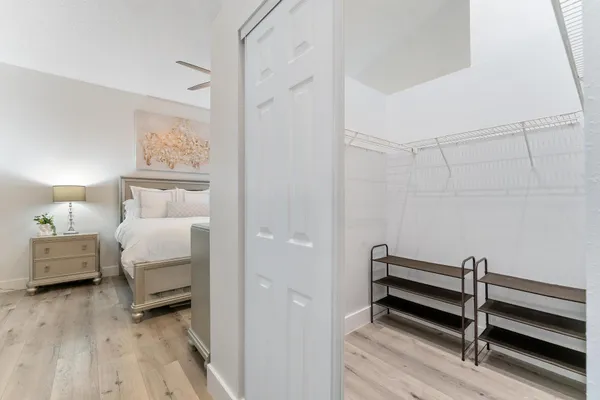 a bedroom with a bed and a night stand