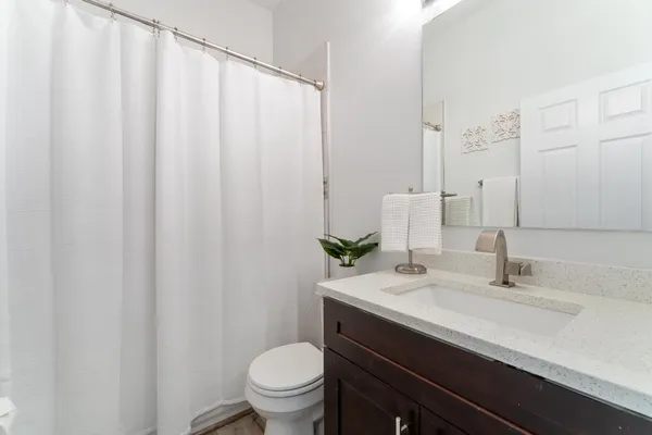 a bathroom with a sink a toilet and a mirror