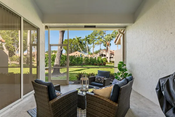 a roof deck with couch and garden view