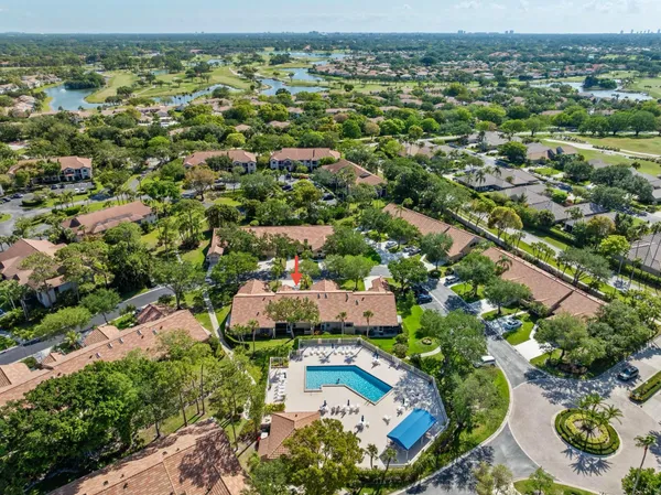 an aerial view of residential houses with outdoor space and trees