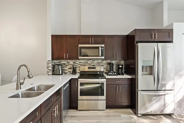 a kitchen with a sink a stove and refrigerator