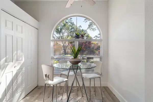 a view of a room that has a bed and a table in it