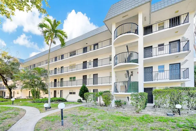 a front view of a building with garden