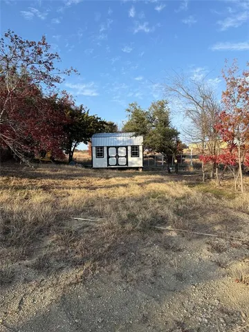 a view of a house with a yard and sitting area