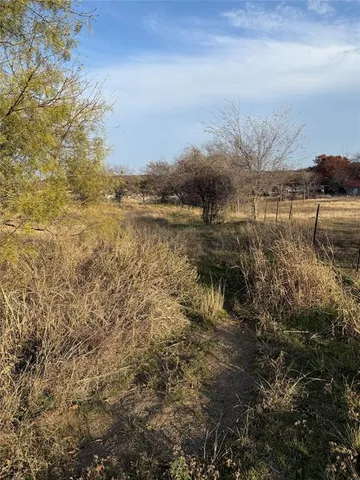 a view of a lake with houses in back