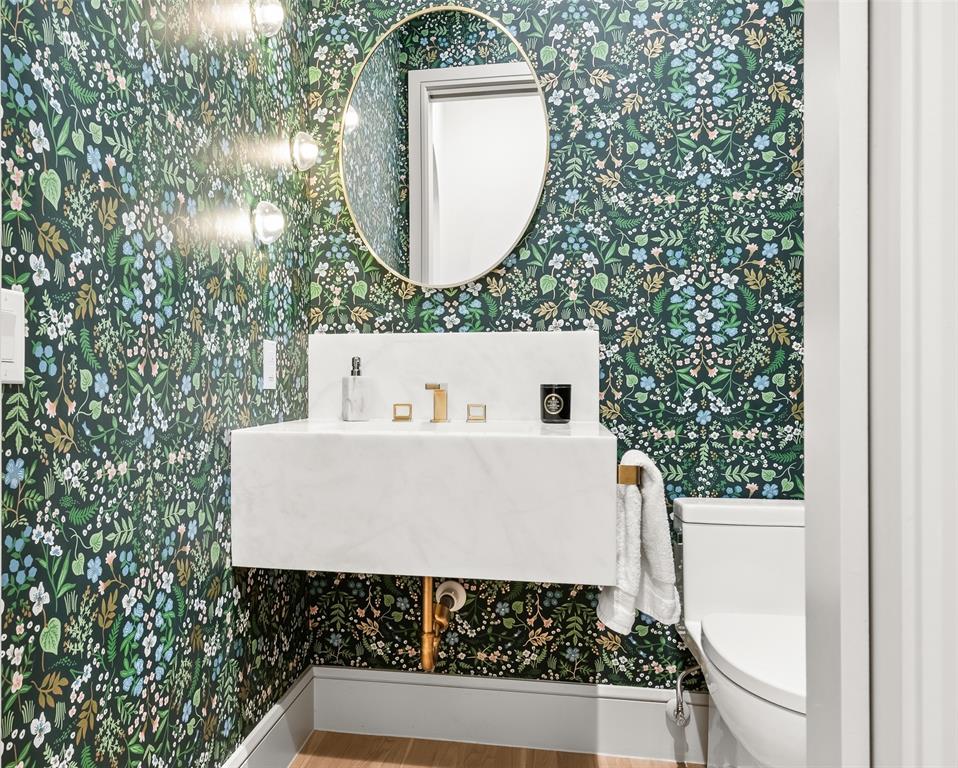 7158 Pasadena Avenue Dallas, TX 75214 - Photo 15 of 39 Powder bath featuring wallpapered walls, marble vanity, and wood floors