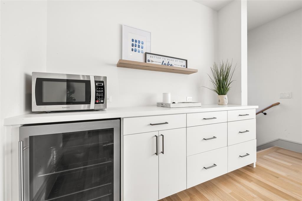 7158 Pasadena Avenue Dallas, TX 75214 - Photo 30 of 39 Guest house kitchenette featuring white cabinetry, open shelves, refrigerator, light countertops, and stainless steel microwave